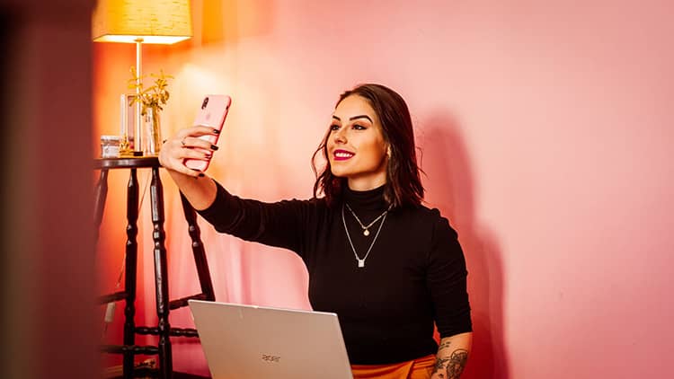 woman black long sleeve blouse taking selfie
